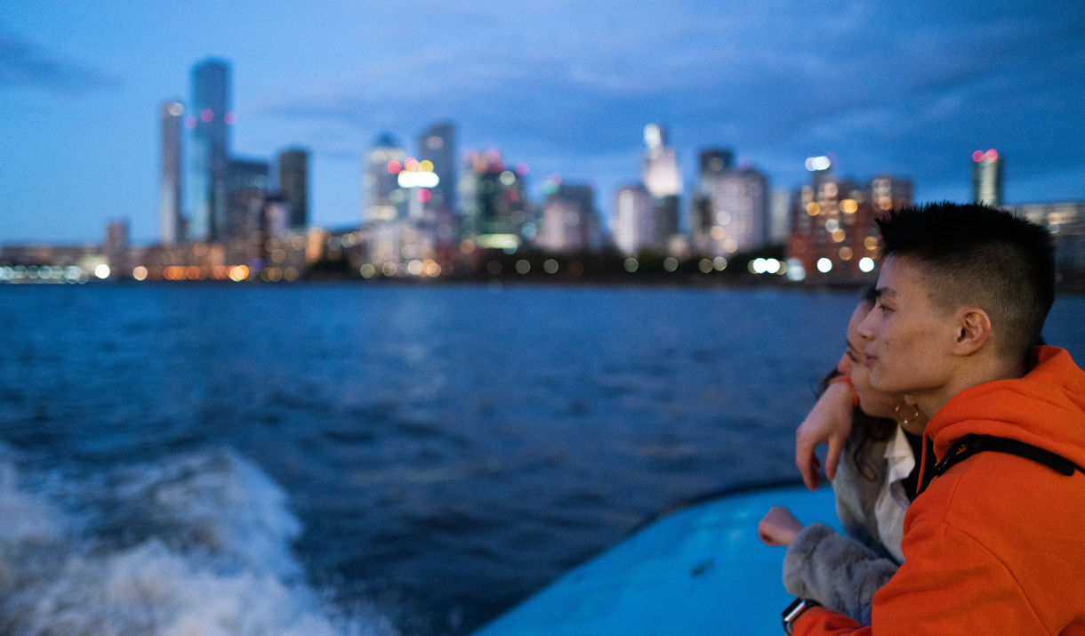 Couple enjoy night time views on Uber Boat by Thames Clippers